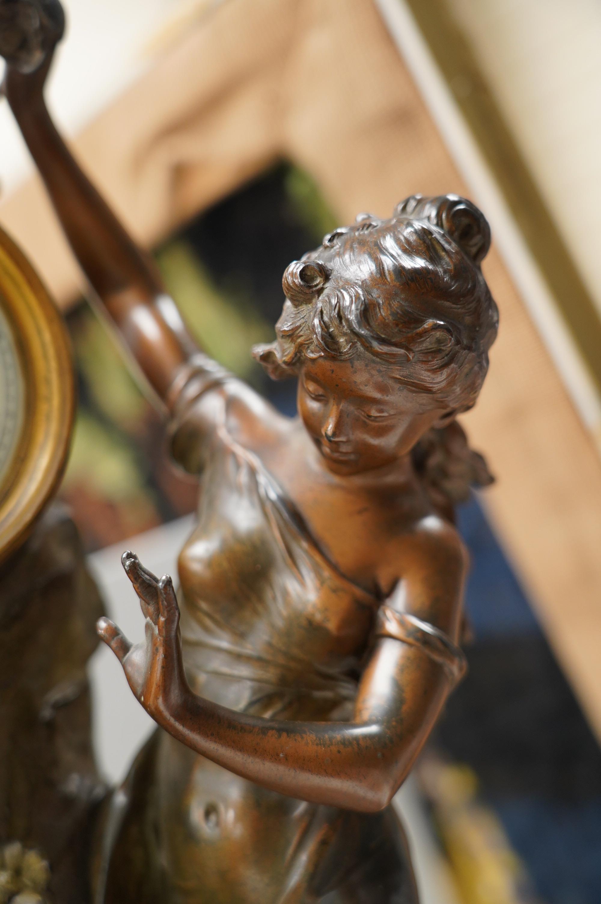 A French Art Nouveau spelter patinated figural table clock, ‘Jardin D’Amour’, with a late 19th century movement striking on a bell, height 53cm. Condition - good